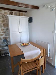 een kamer met een houten tafel met een kom erop bij locationseians var studio mimosa 2 etage in Seillans