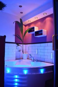 a bathroom with a large tub with a plant in it at SinueSsa in Cologne +36 photos
