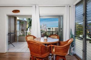 a porch with a table and chairs on a balcony at Alii Villas 340 in Kailua-Kona
