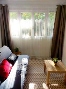 a bedroom with a bed and a table and windows at Studio Plages Vélodrome by Villa Reiala in Marseille