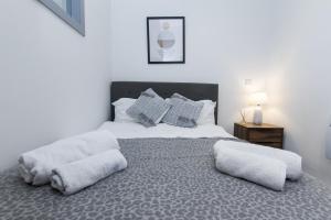 a bedroom with a large bed with two pillows at K Suites - Oak Court in Brierley Hill