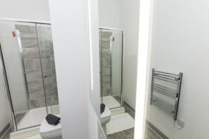 a bathroom with two toilets and a shower at K Suites - Oak Court in Brierley Hill