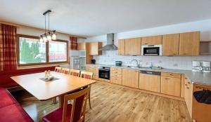 a kitchen with a wooden table and a dining room at Hallerhaus in Altenmarkt im Pongau