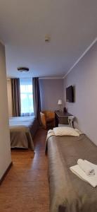 Postel nebo postele na pokoji v ubytování Primo Hotel
