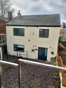 a white house with a blue door at Hunters Lodge, with parking for one car in Lincoln