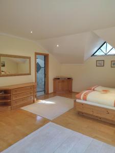 a bedroom with a bed and a dresser and a mirror at Tauern Haus in Untertauern