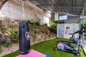 a punching bag hanging from a building with a scooter at Chakalaka Resort in Vlikhon