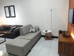 a living room with a couch and a table at Argolawu Homestay in Tawangmangu