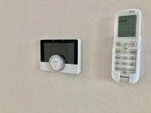 a cell phone is attached to a wall at Alloggio Nala 6 in Biella