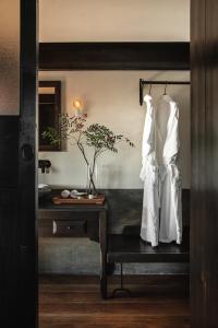 a room with a table and white robes on a wall at Anyu Hotel Dali in Dali