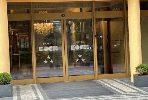 an entrance to a hotel with glass doors and a chandelier at Hotel Koch in Kętrzyn