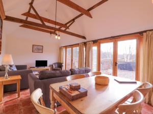 a living room with a table and a couch at Avocet Cottage in Saxmundham