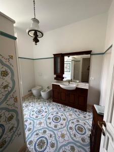 Villa San Giorgio vista mare Alassio في ألاسيو: حمام مع حوض ومرحاض ومرآة
