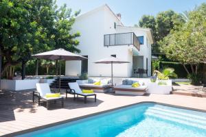 a patio with a swimming pool and a house at Casa Guindilla in Portals Nous
