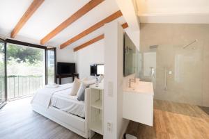 a bedroom with a bed and a sink and a shower at Casa Guindilla in Portals Nous +19 photos