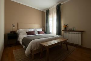 Postel nebo postele na pokoji v ubytování Hotel Siuranella
