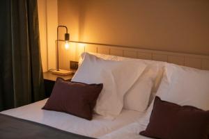 Postel nebo postele na pokoji v ubytování Hotel Siuranella
