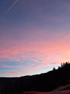 a colorful sky with trees in the background at Appartement au pied des pistes avec grande terrasse in Orbey