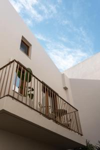 a balcony of a white building with a sky at Cortiletto Timeless Suites in Rethymno
