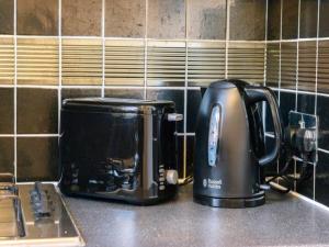 a toaster and coffee maker on a kitchen counter at Pass the Keys Kings Cross Urban Escape in London