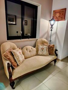 a couch with pillows on it in a living room at Prime Located Home by *The Sea* in Sliema +19 photos