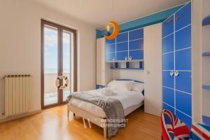 a bedroom with a bed and a large window at Wanderlust Experience Portsea Apartment in Giovinazzo
