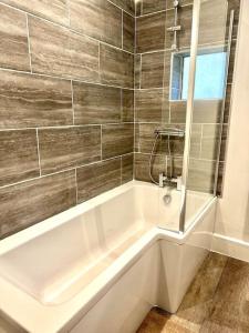 a white bath tub in a bathroom at Modernised cottage Sleeps Six in Ore