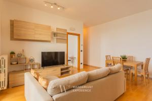 a living room with a couch and a television at Wanderlust Experience Portsea Apartment in Giovinazzo