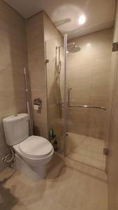 a bathroom with a toilet and a shower at The Wonder Bay Halong studio in Ha Long