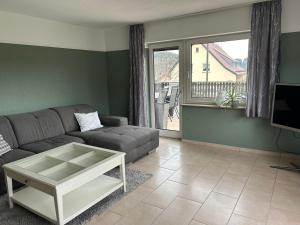 a living room with a couch and a coffee table at Eifel Ferienwohnung Thiel in Oberstadtfeld