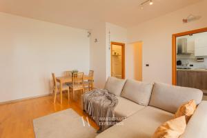 a living room with a couch and a table at Wanderlust Experience Portsea Apartment in Giovinazzo