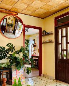 a room with a door and a mirror and plants at Ame Soeur Đà Lạt in Da Lat