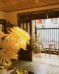 a room with a door with flowers and a table at Ame Soeur Đà Lạt in Da Lat