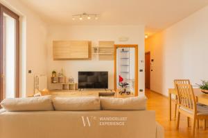 a living room with a couch and a television at Wanderlust Experience Portsea Apartment in Giovinazzo