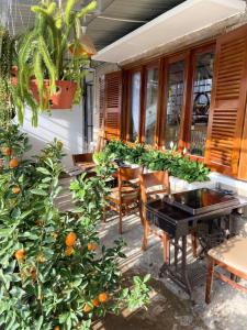 a table and chairs on a porch with oranges at Ame Soeur Đà Lạt in Da Lat
