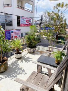 a patio with a picnic table and potted plants at Ame Soeur Đà Lạt in Da Lat