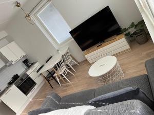 a living room with a couch and a flat screen tv at Riverside cozy flat in Porvoo in Porvoo
