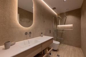 a bathroom with a sink and a toilet and a mirror at Hot Tub - 5 min to Beaches - Netflix - Full Kitchen in Kos +10 photos