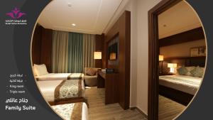een hotelkamer met 2 bedden en een spiegel bij Violet Al Shisha Hotel in Mekka