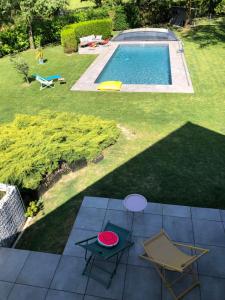 einem roten Frisbee auf einem Tisch neben einem Pool in der Unterkunft Maison d'hôtes kerwall in Malville