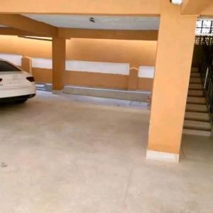 a garage with a car parked in it at Leo's Enchanting homes in Mombasa