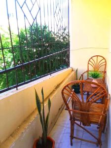 a balcony with two chairs and a table and a window at Leo's Enchanting homes in Mombasa