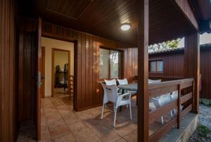 a porch of a house with a table and chairs at Camping Rural Ria de Arosa 2 in Ribeira