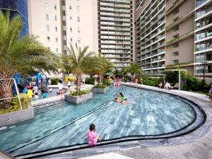 a pool at a resort with people playing in it at Căn hộ nghỉ dưỡng 5 sao The Sóng Vũng Tàu in Vung Tau