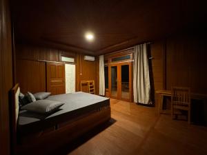 a bedroom with a large bed in a room at MC Bunaken Inn & Dive in Bunaken