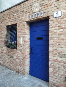 a blue garage door on a brick building at Trilocale vista mare con 2 bagni nel centro storico - Agenzia Cocal in Caorle