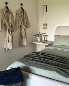 a bedroom with a bed and towels hanging on the wall at Ten Acres in Beechmont