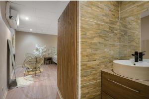 a bathroom with a sink and a table at L'escapade in Auriol