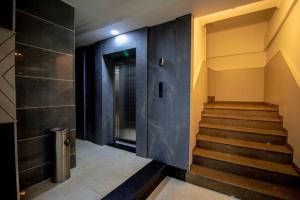 a hallway with stairs and a door in a building at Hotel German Residency , Srinagar in Srinagar