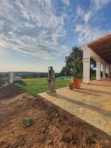 a porch of a house with a view of a field at CASA RURAL MONTE DE AJUDA in Olivenza